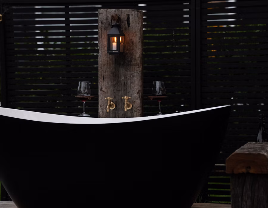 Brass taps and candlelight at the Campbell Cottage outdoor bath